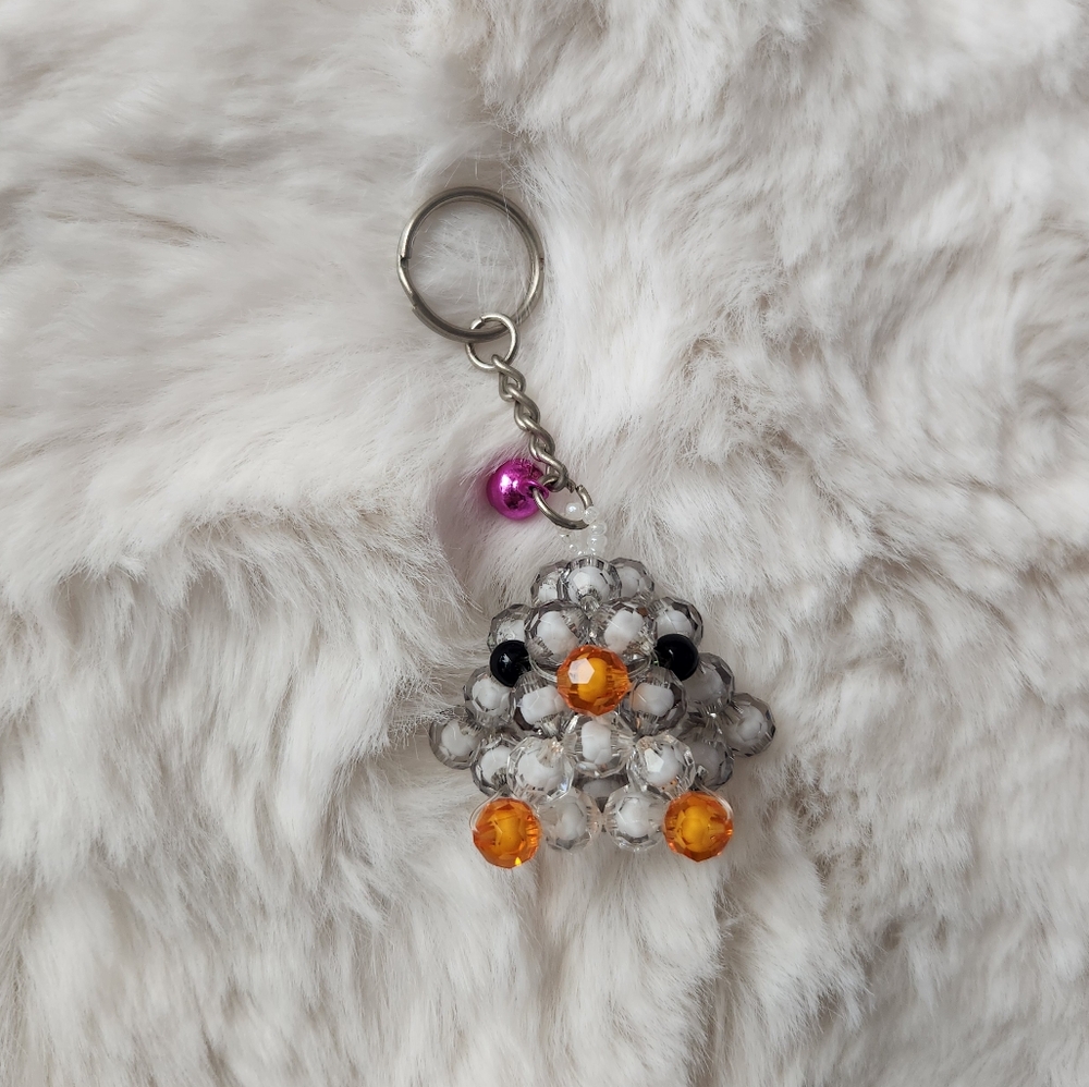 Handmade gray white and orange beaded penguin charm